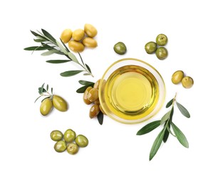 Image of Bowl of oil, ripe olives and leaves on white background, top view