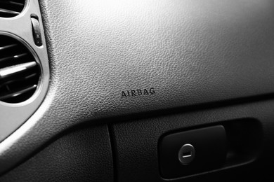 Safety airbag sign on dashboard in car, closeup
