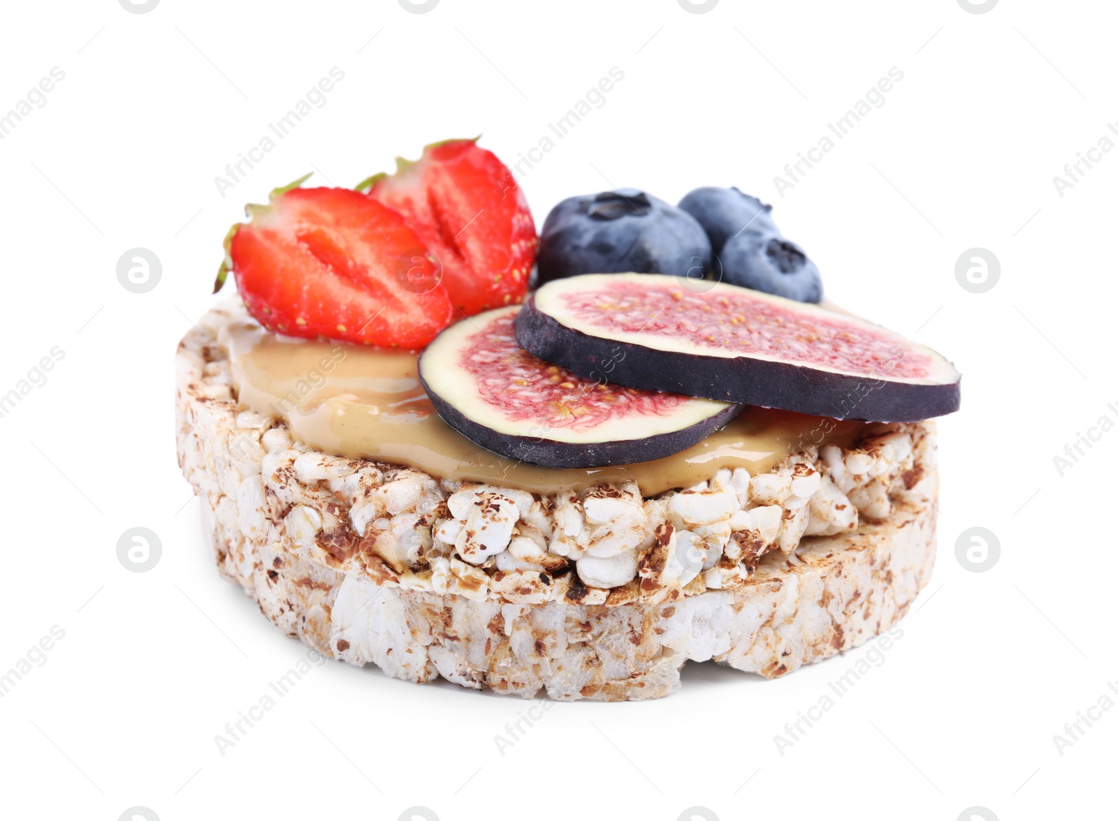Photo of Tasty crispbread with peanut butter, berries and figs on white background