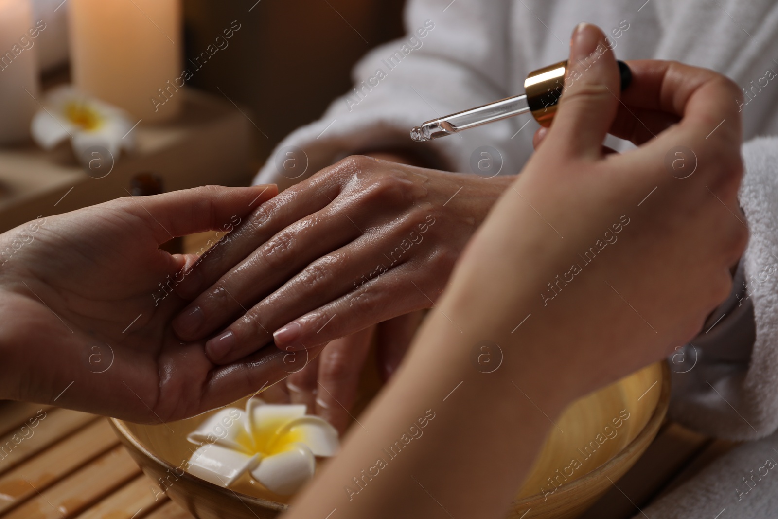 Photo of Woman receiving hand treatment in spa, closeup