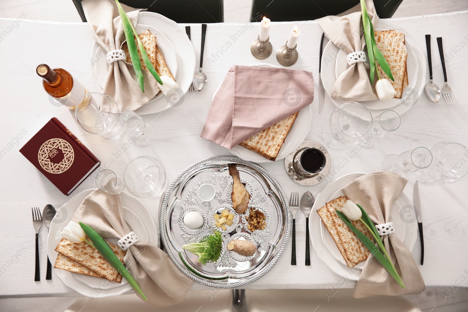 Photo of Festive Passover table setting with Torah, top view. Pesach celebration