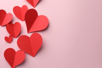 Photo of Paper hearts on pink background, flat lay. Space for text