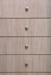 Wooden wardrobe drawers as background, closeup view