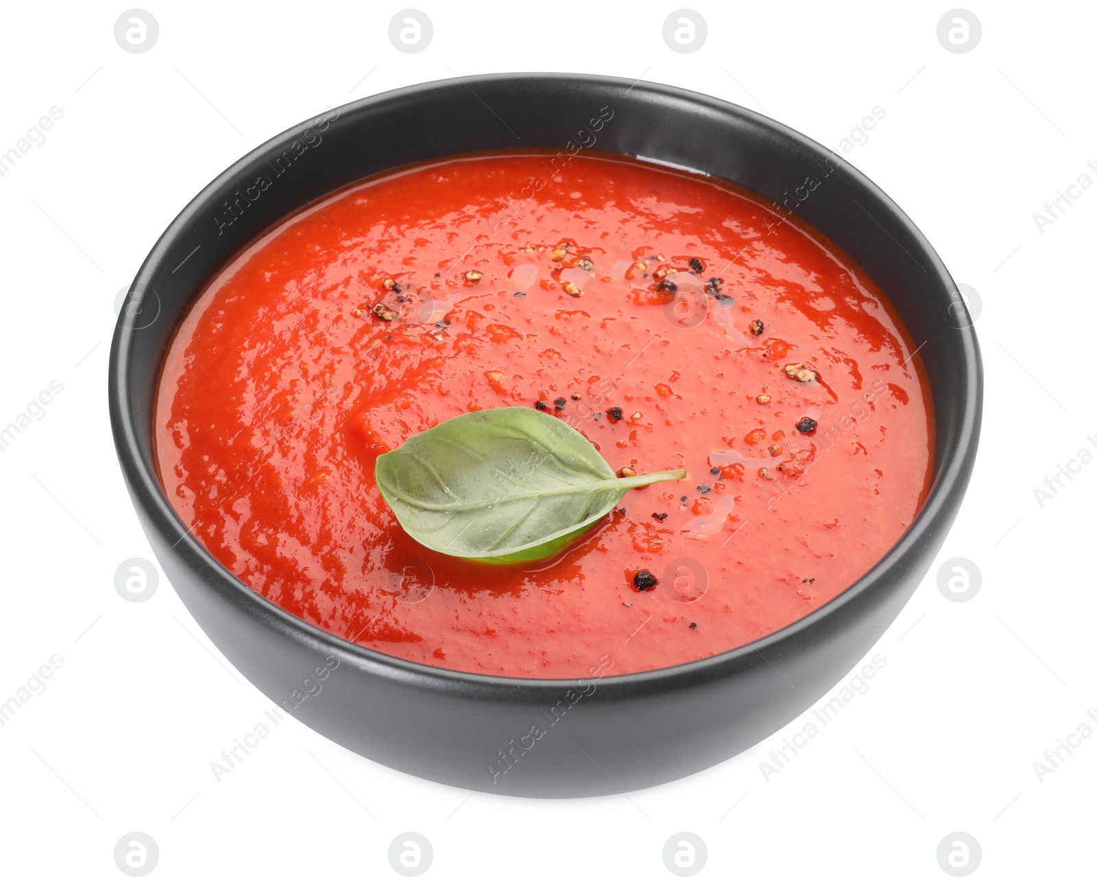 Photo of Delicious tomato cream soup in bowl isolated on white