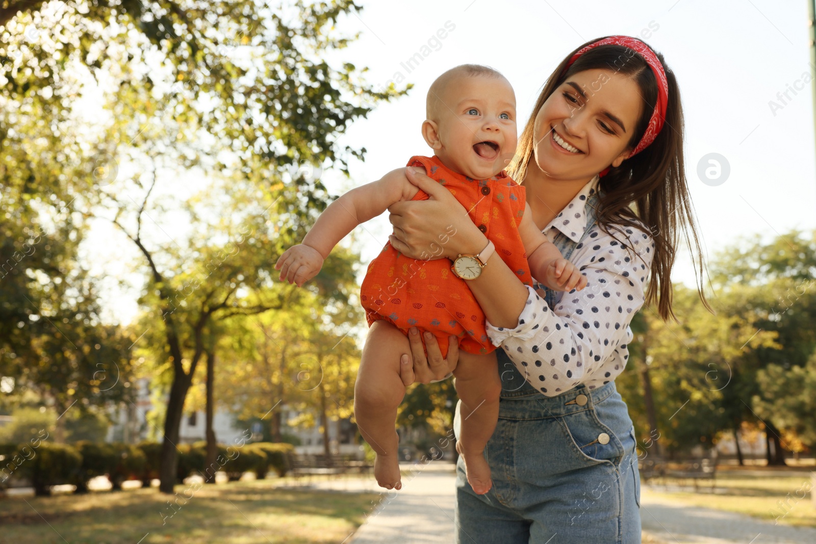 Photo of Young mother with her cute baby in park on sunny day