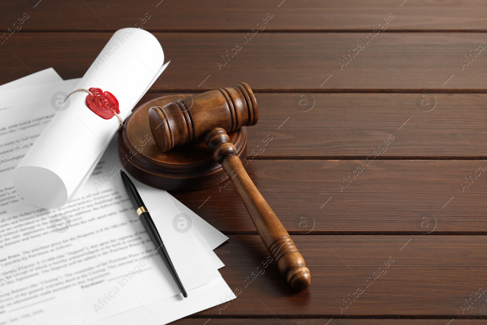 Photo of Notary contract. Documents, gavel and pen on wooden table, space for text