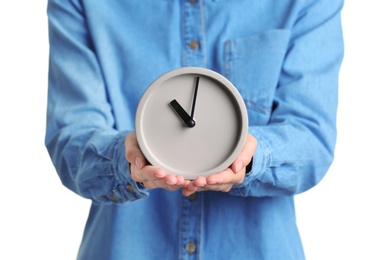 Young woman holding alarm clock on white background. Time concept