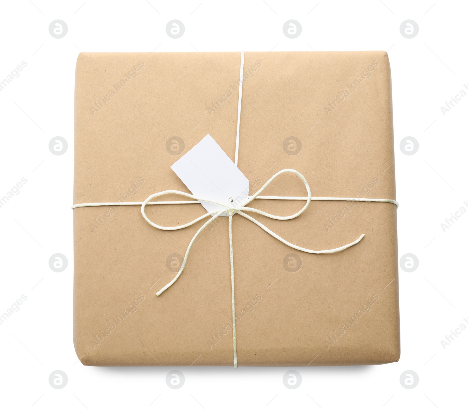 Photo of Parcel wrapped in kraft paper with tag on white background, top view