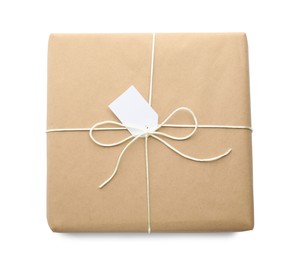 Parcel wrapped in kraft paper with tag on white background, top view