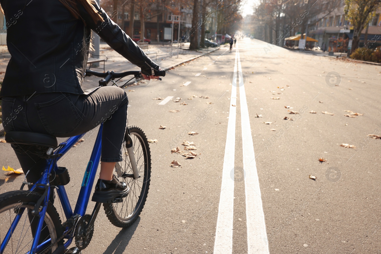 Photo of Woman with bicycle on lane in city, closeup