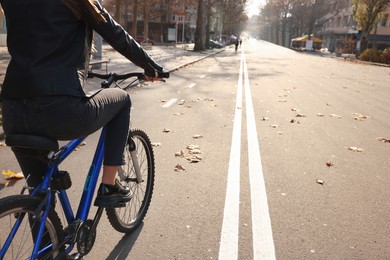 Photo of Woman with bicycle on lane in city, closeup