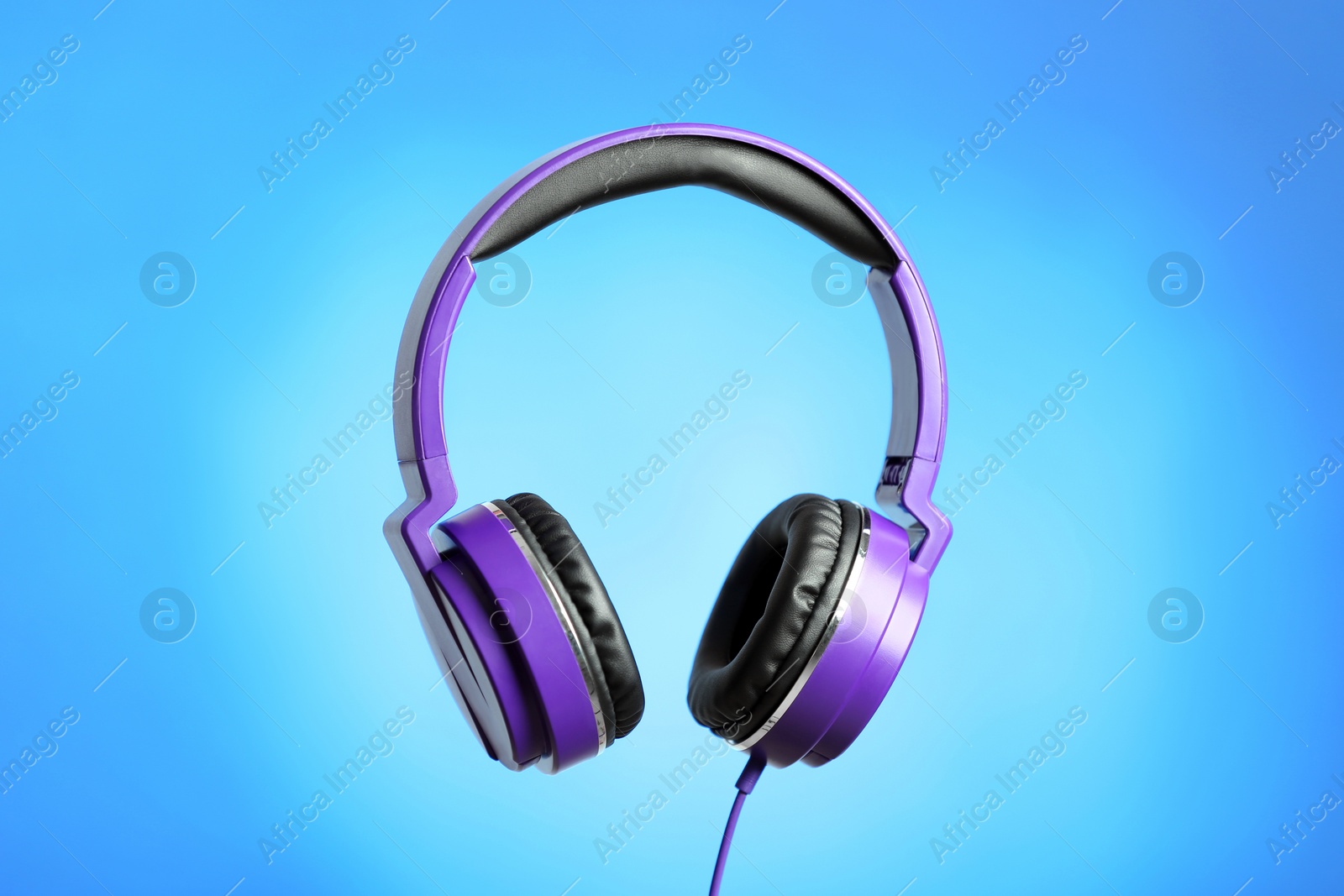 Photo of Stylish headphones with pads on color background