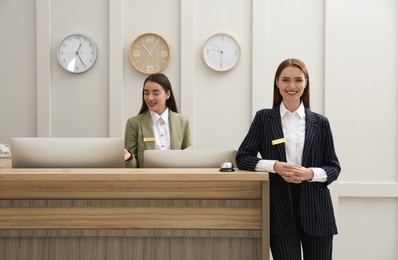 Photo of Beautiful receptionists working at counter in hotel