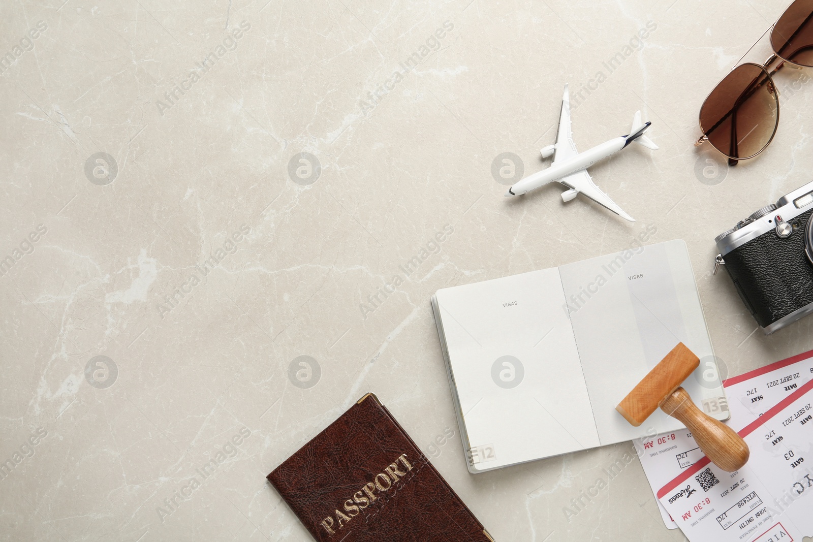 Photo of Flat lay composition with passports, stamp and flight tickets on light table, space for text