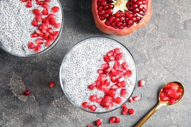 Tasty chia seed pudding with pomegranate served on table, flat lay