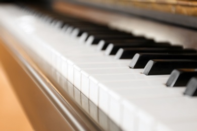 Photo of Black and white piano keys indoors, closeup