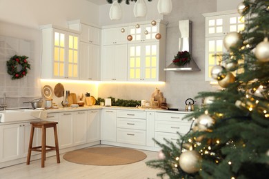 Photo of Cozy spacious kitchen decorated for Christmas. Interior design