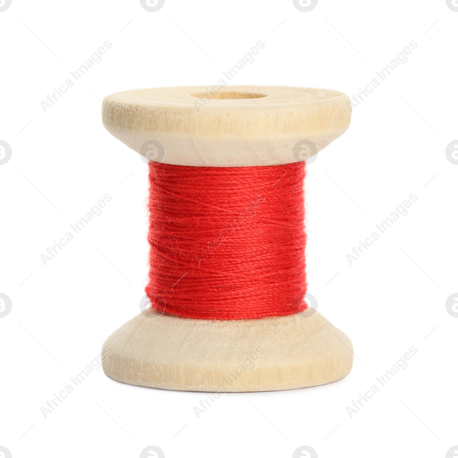 Photo of Wooden spool of red sewing thread isolated on white