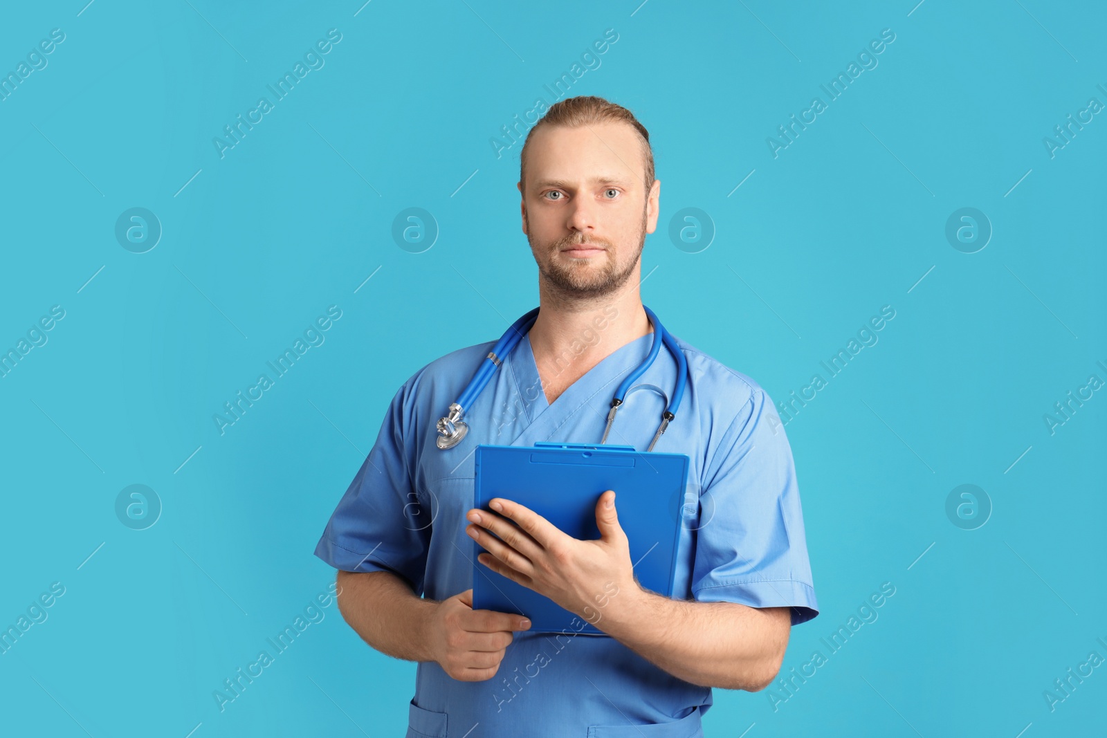 Photo of Portrait of medical assistant with stethoscope and clipboard on color background