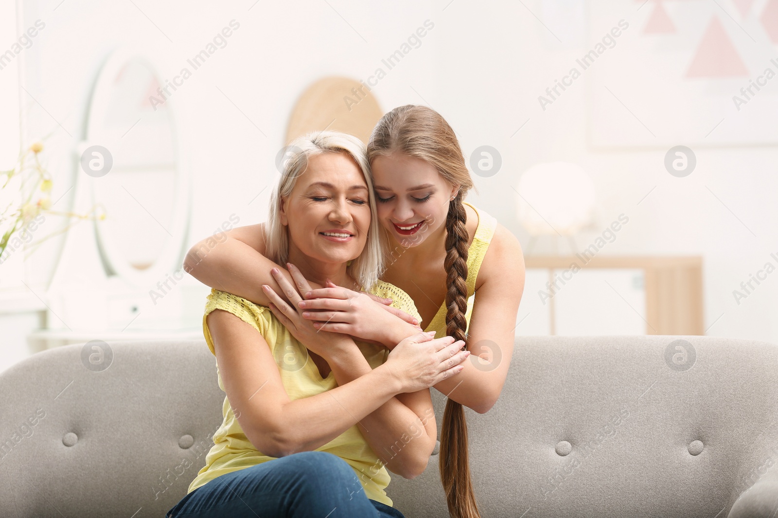 Photo of Mother and her adult daughter spending time together at home