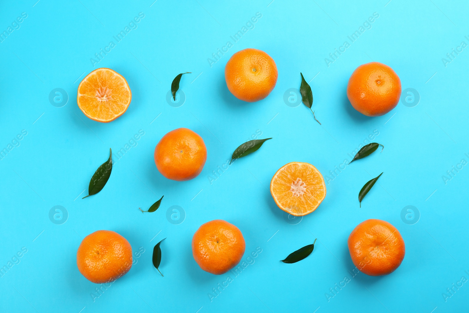 Photo of Flat lay composition with tangerines on blue background