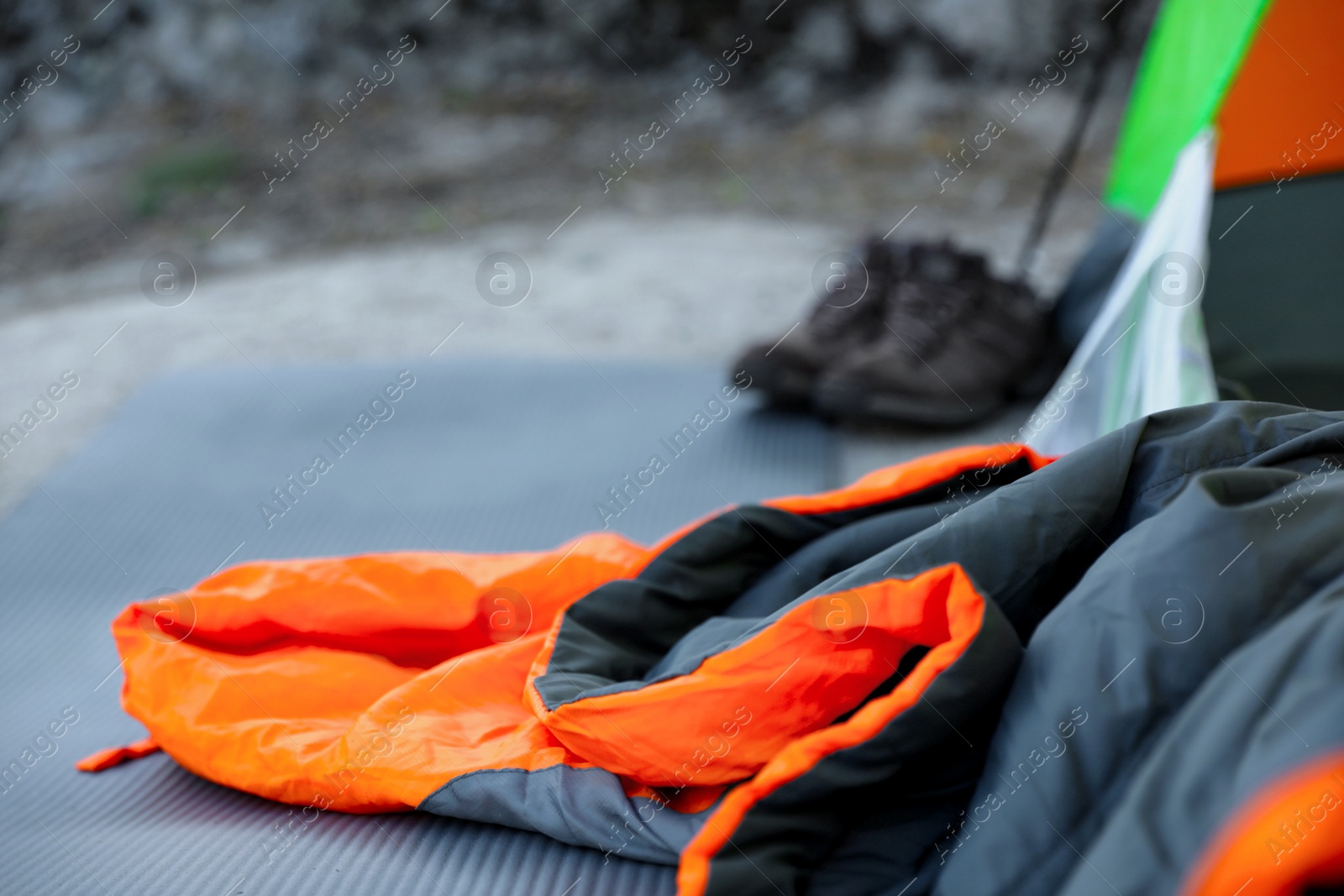 Photo of Sleeping bag and other camping gear outdoors