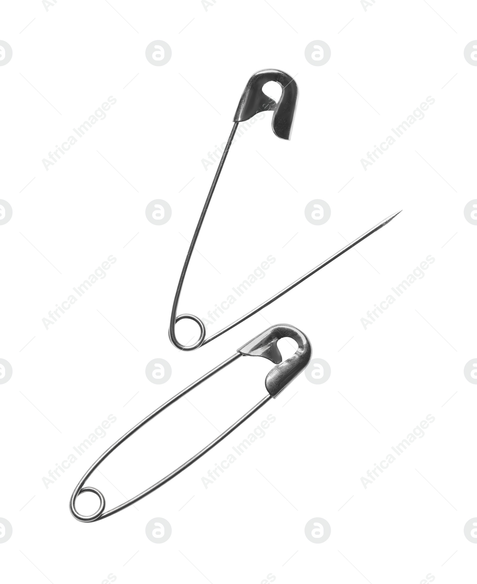 Photo of Metal safety pins on white background, top view