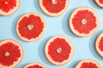 Photo of Fresh sliced ripe grapefruit on color background, flat lay