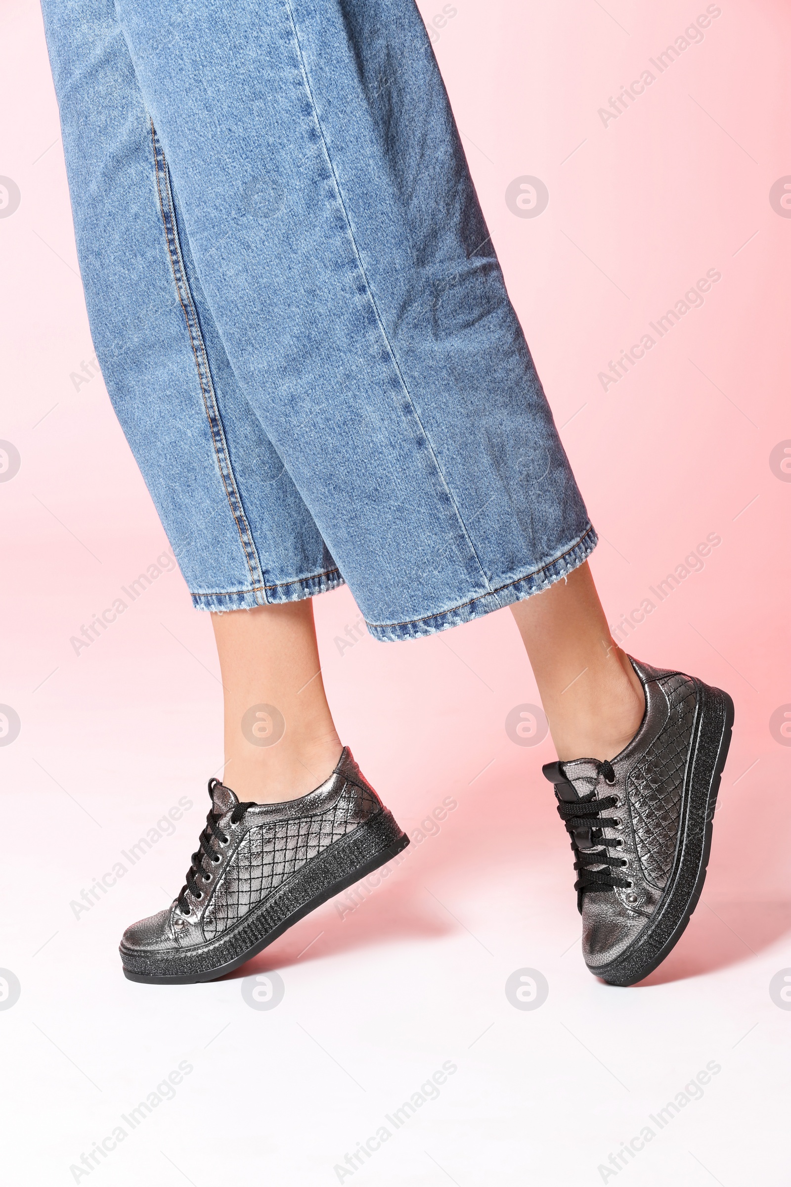 Photo of Woman in stylish shoes on color background, closeup