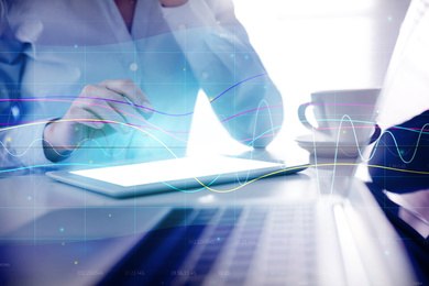 Image of Forex trading. Double exposure of charts and woman using tablet computer, closeup