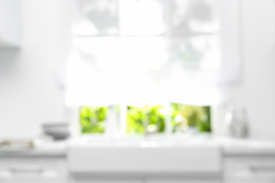Photo of Blurred view of modern kitchen with window