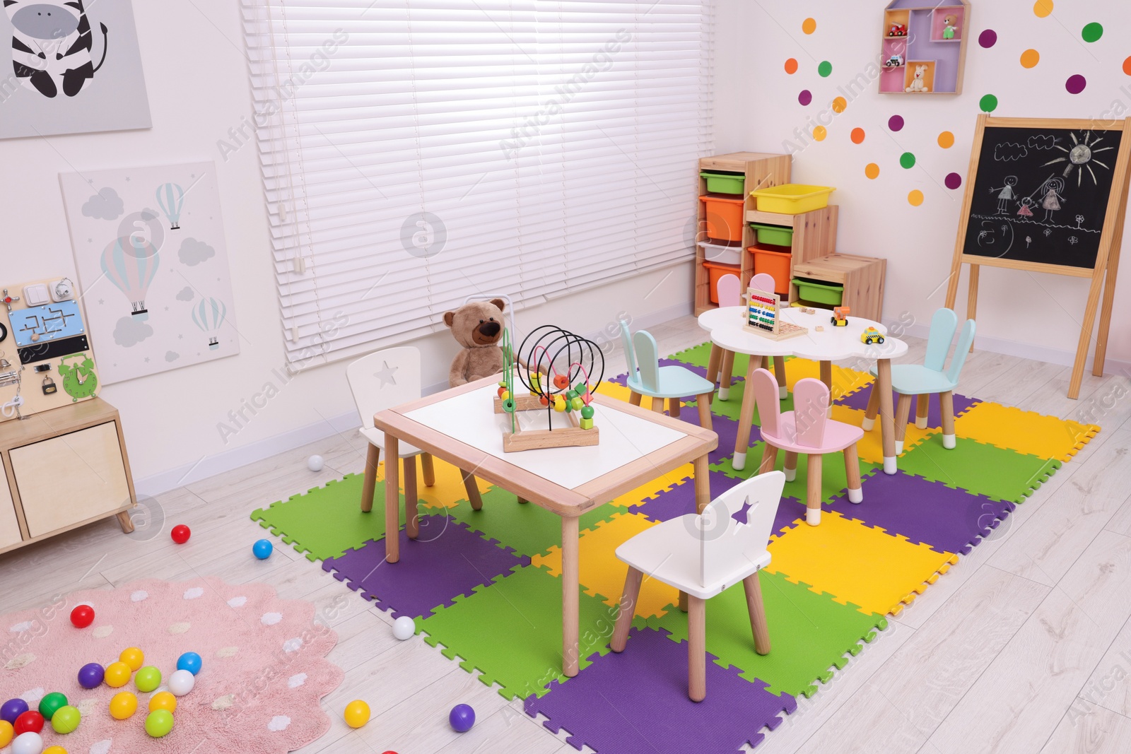 Photo of Stylish kindergarten interior with toys and modern furniture, above view