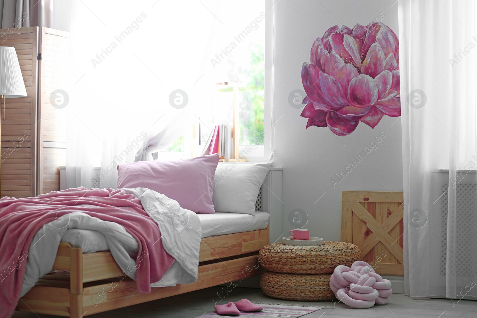 Photo of Stylish room interior with comfortable bed near decorated wall