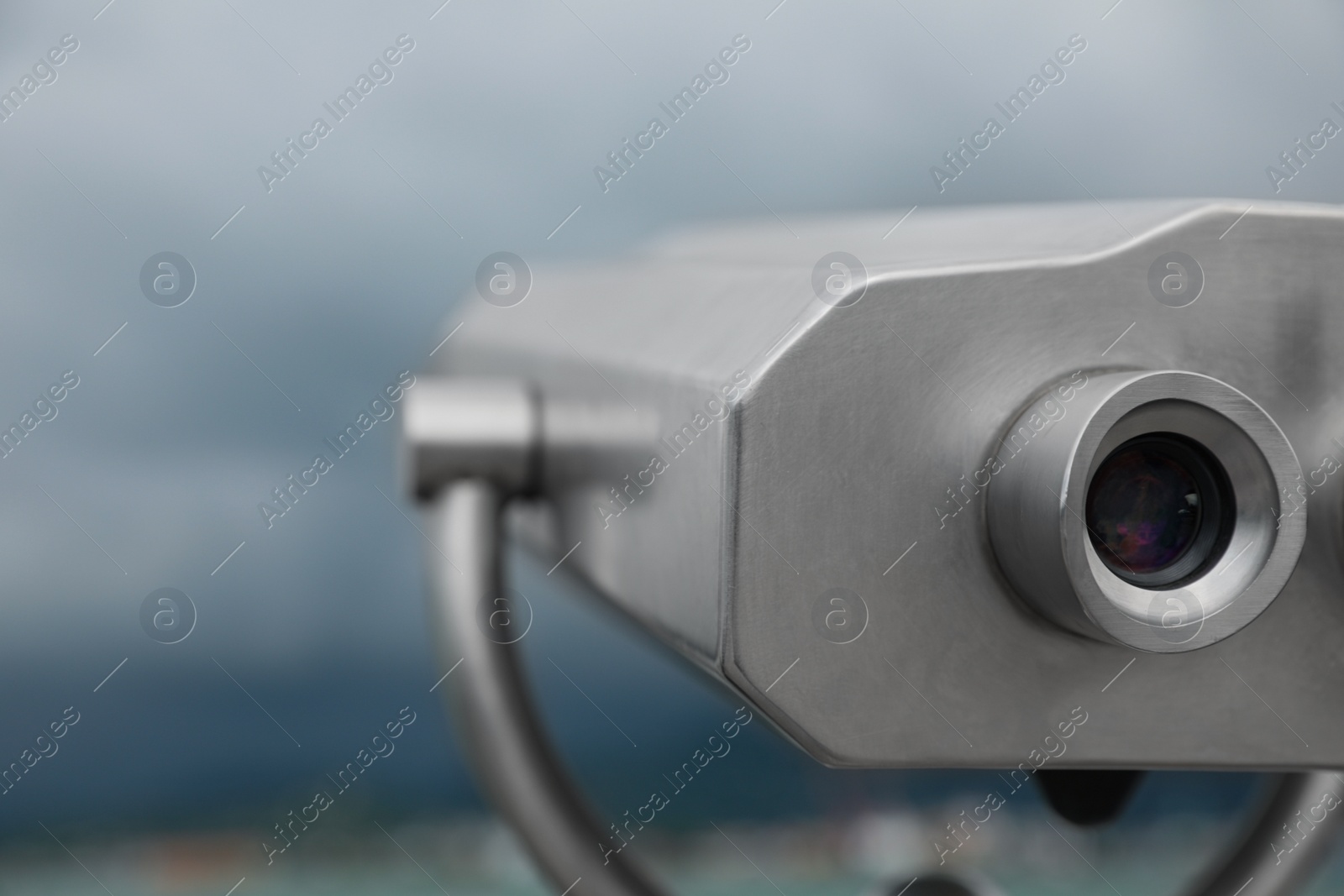 Photo of Metal tower viewer installed near sea, closeup with space for text. Mounted binoculars