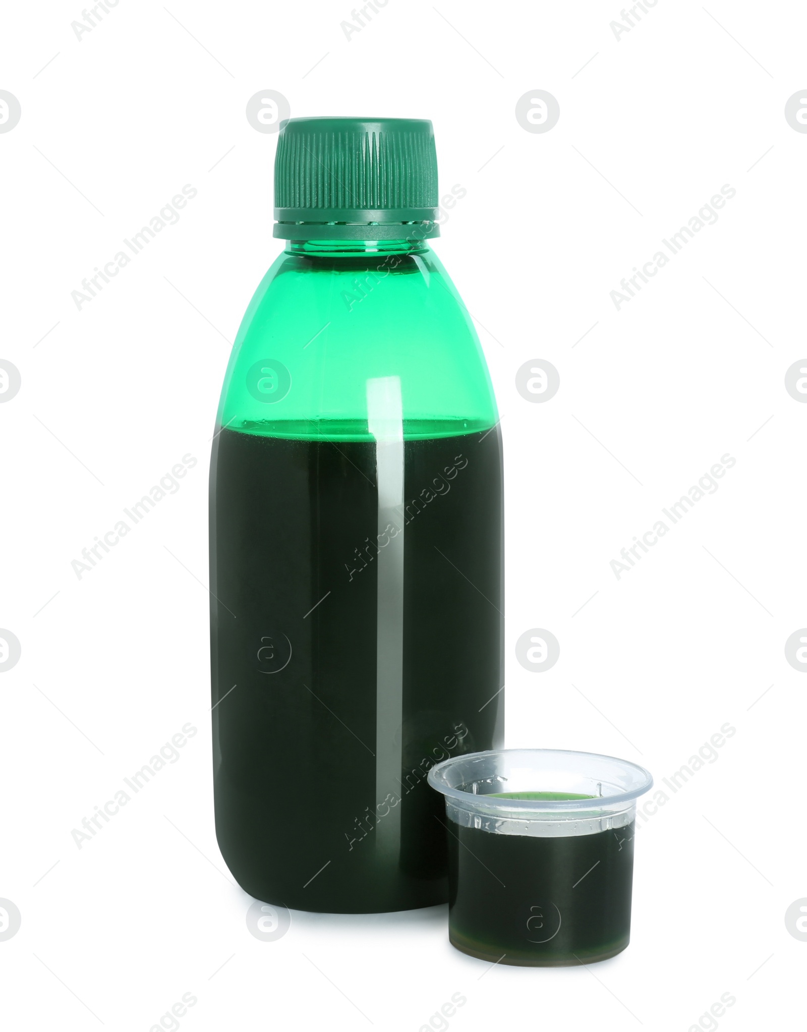 Photo of Bottle of cough syrup and measuring cup on white background