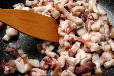 Photo of Frying cracklings in cookware, closeup. Pork lard