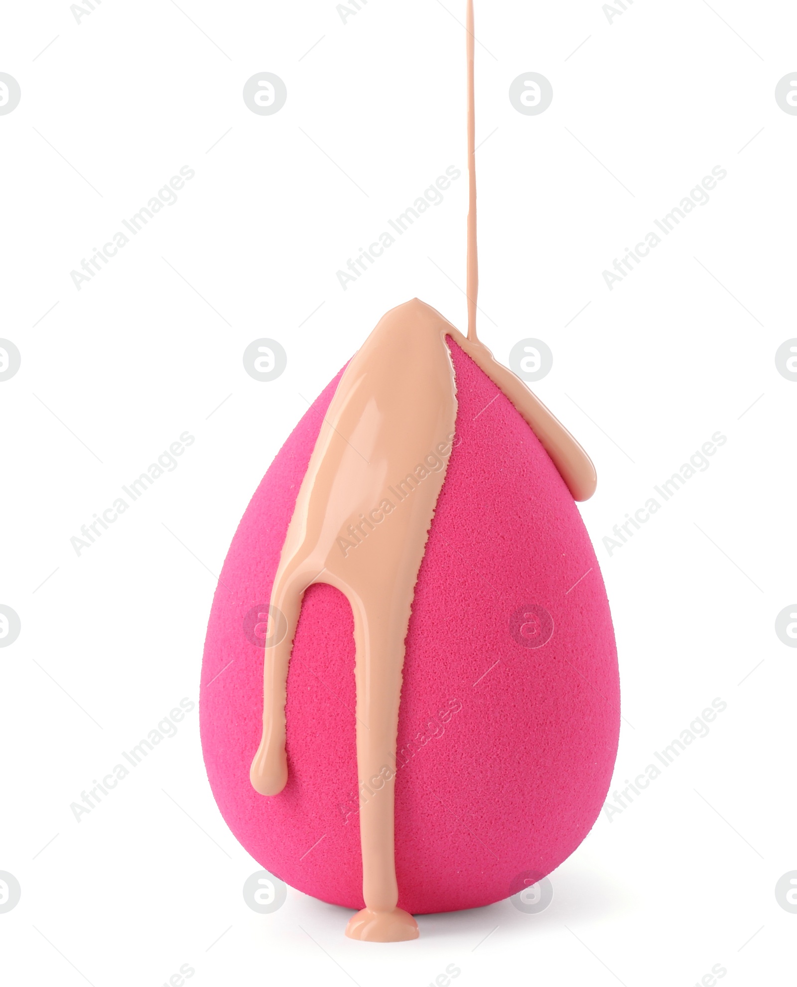 Photo of Pouring skin foundation onto pink makeup sponge isolated on white
