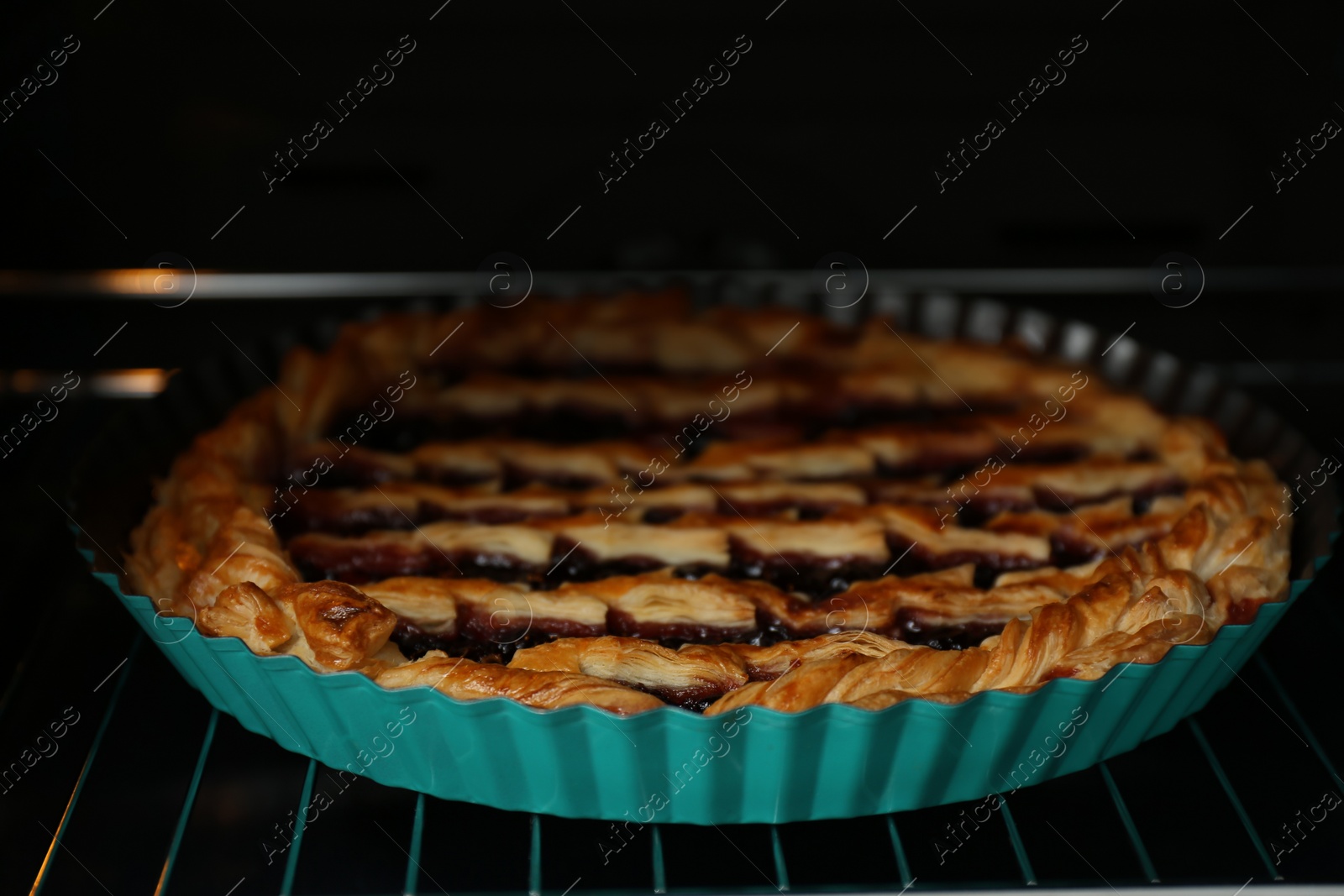 Photo of Delicious fresh homemade cake in oven, closeup