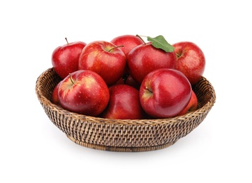 Photo of Wicker bowl of ripe juicy red apples with leaf on white background