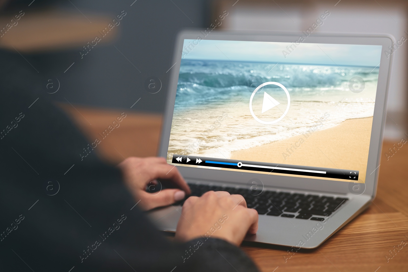 Image of Woman watching video on laptop at office desk, closeup