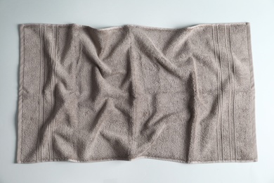 Photo of Fresh fluffy towel on grey background, top view