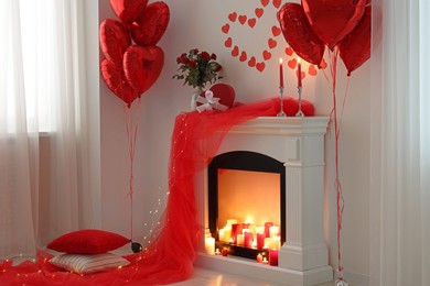 Photo of Stylish room with fireplace and Valentine's day decor. Interior design
