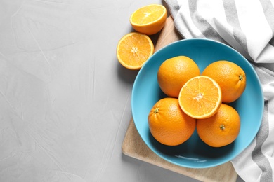 Flat lay composition with ripe oranges and space for text on grey background