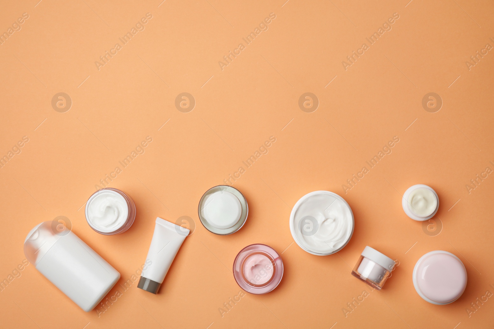 Photo of Flat lay composition with cosmetic products on color background