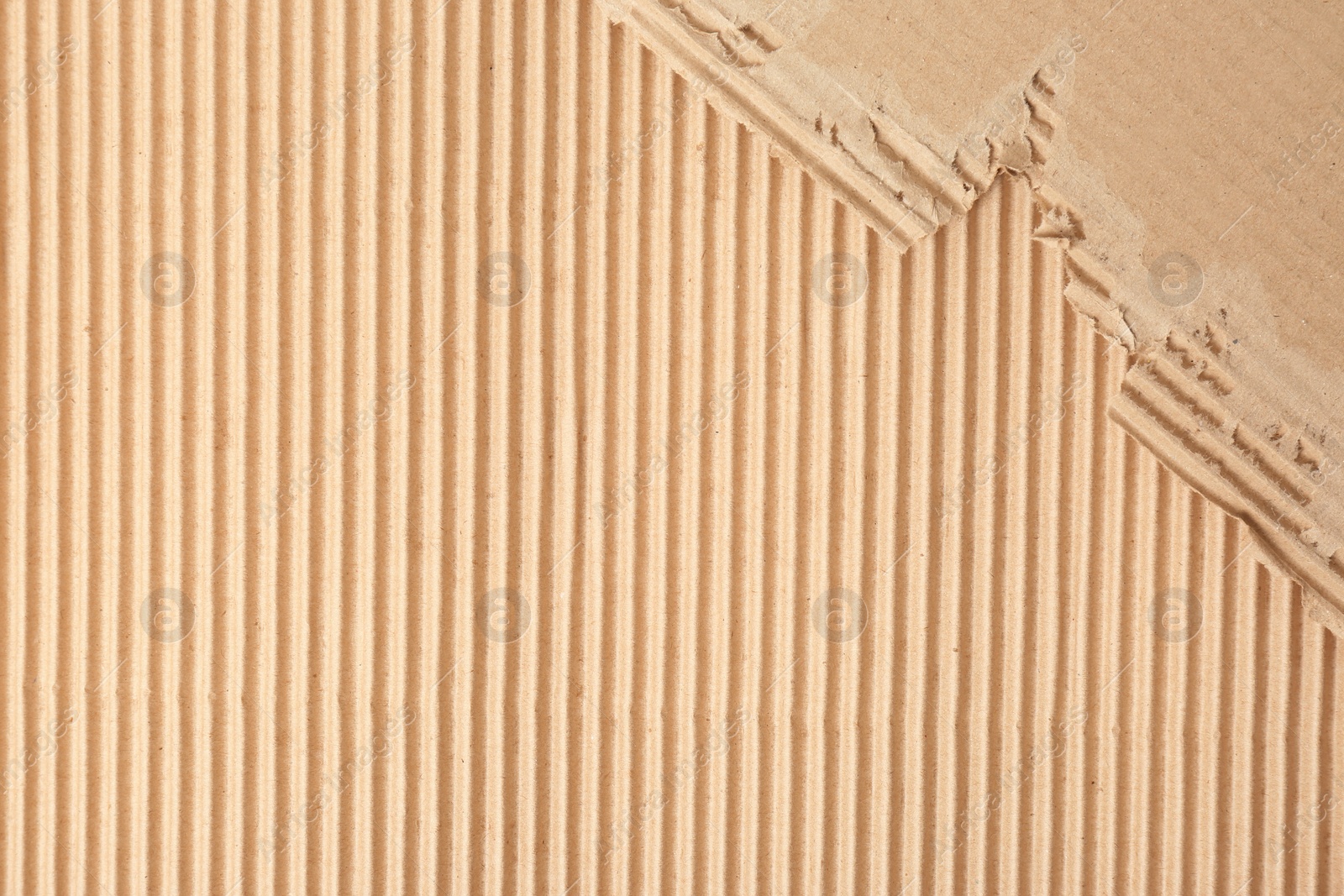 Photo of Corrugated cardboard as background, top view with space for text. Recyclable material