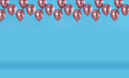 Image of Set of color balloons on blue background. Space for text