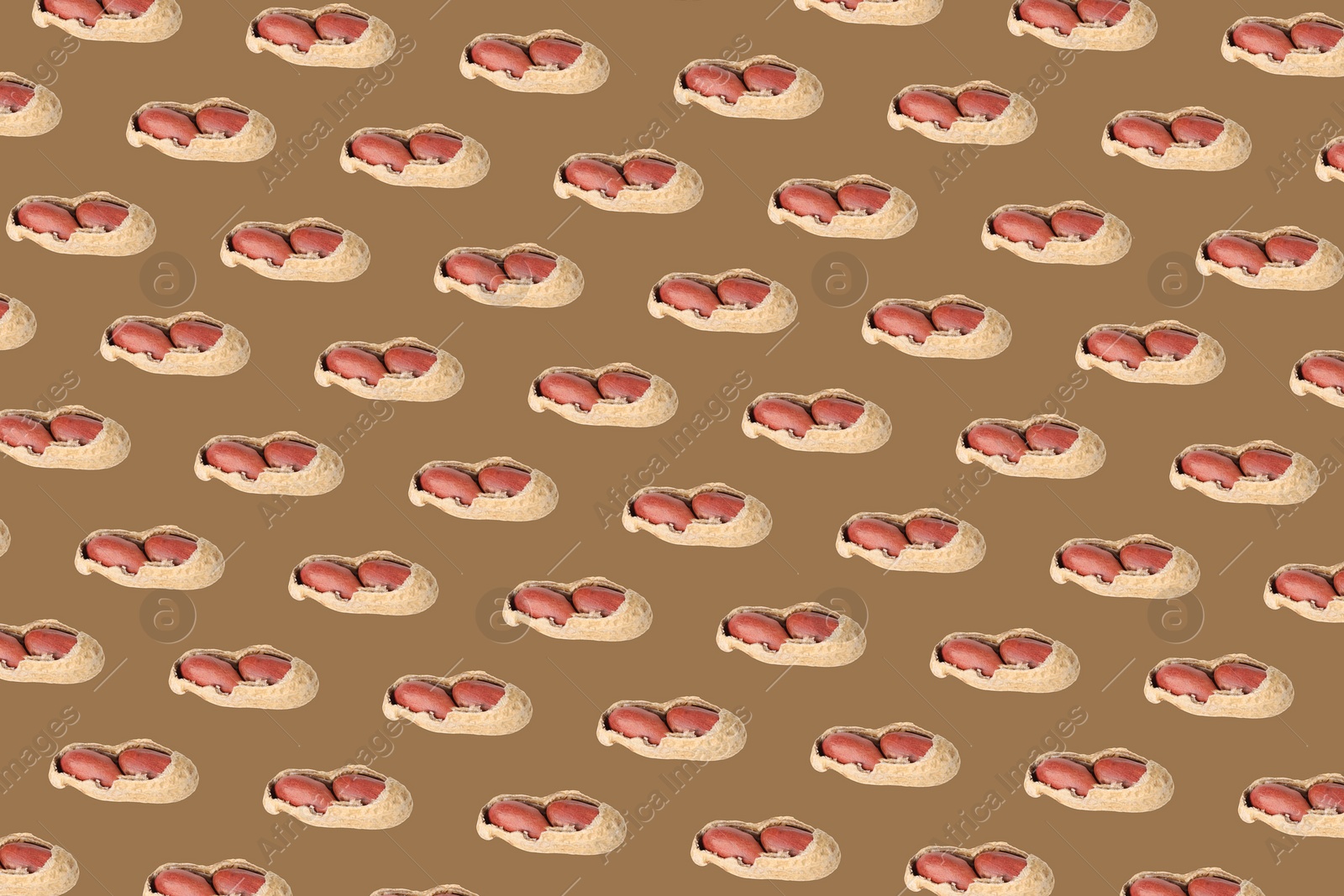 Image of Pattern of unpeeled peanuts on brown background