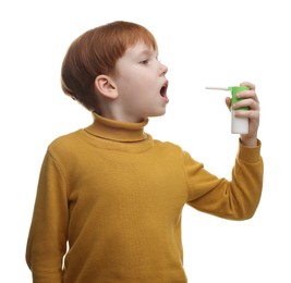 Photo of Little boy using throat spray on white background