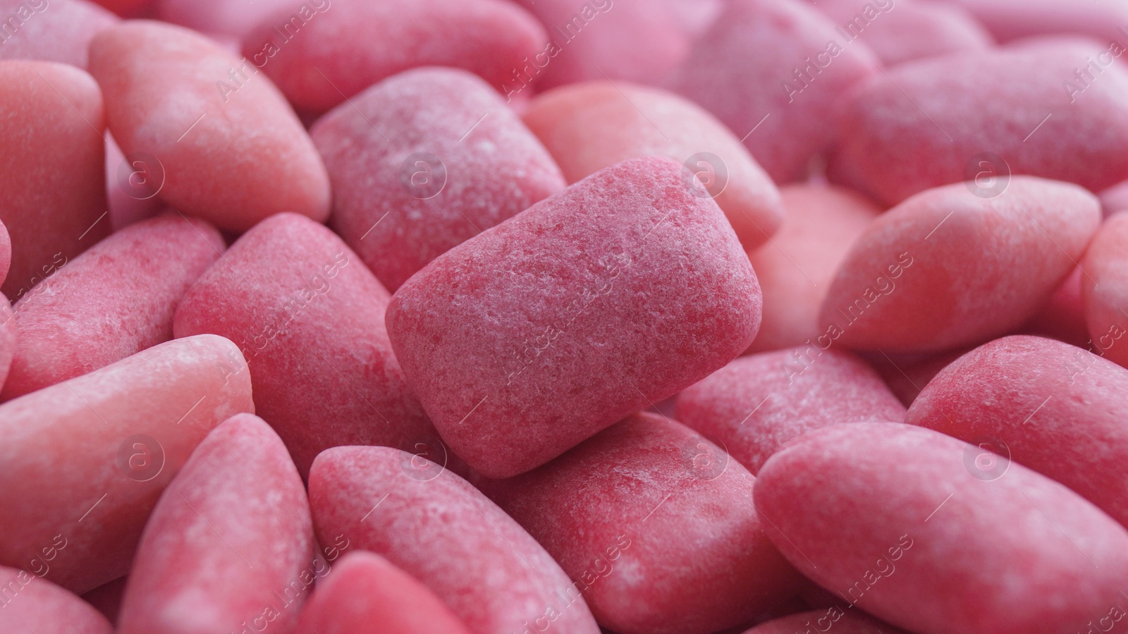 Photo of Many pink chewing gums as background, closeup