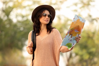 Traveler with world map on blurred background